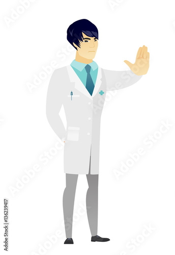 Asian doctor showing stop hand gesture.