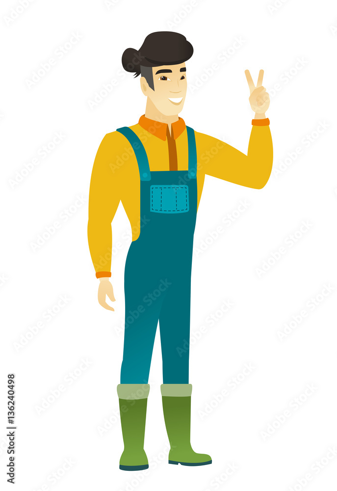 Asian farmer showing the victory gesture. Asian farmer showing the victory gesture.