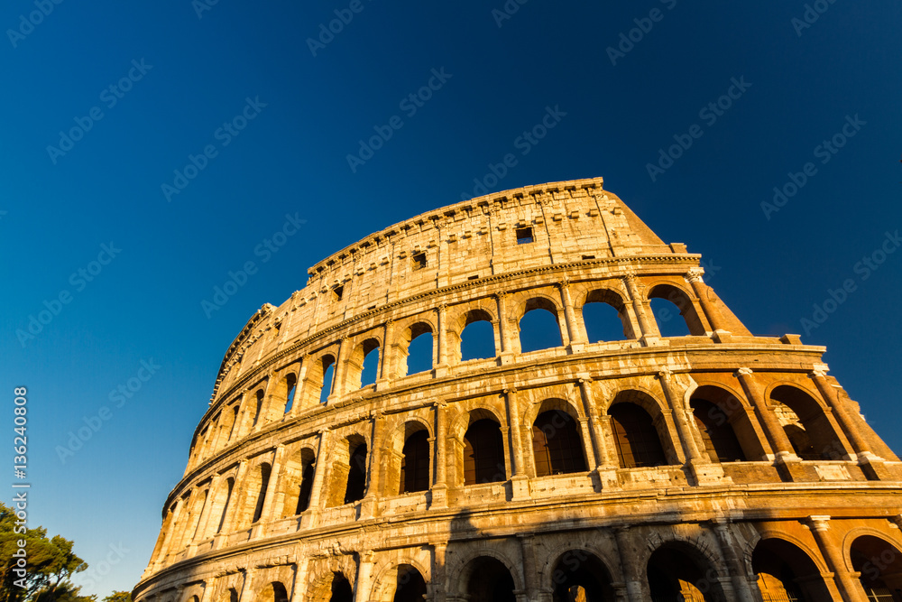 Colosseum or Coliseum Amphitheatre, evening in Rome.