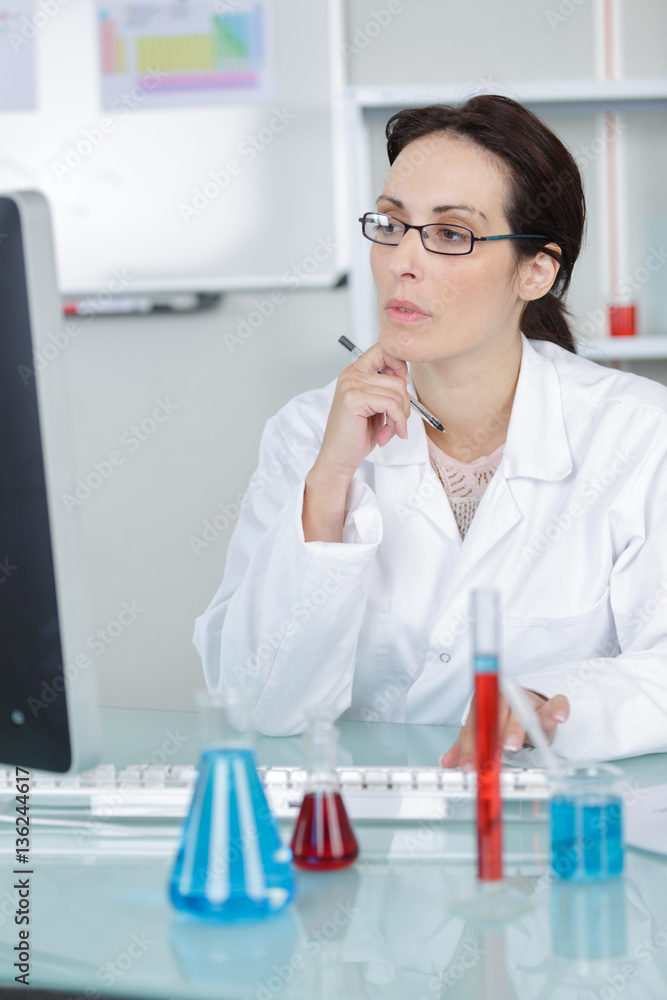 lab worker thoughtful in front of her computer lab worker thoughtful in front of her computer