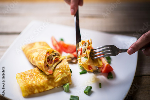 Delicious omlete sliced on a plate; omelet bite photo