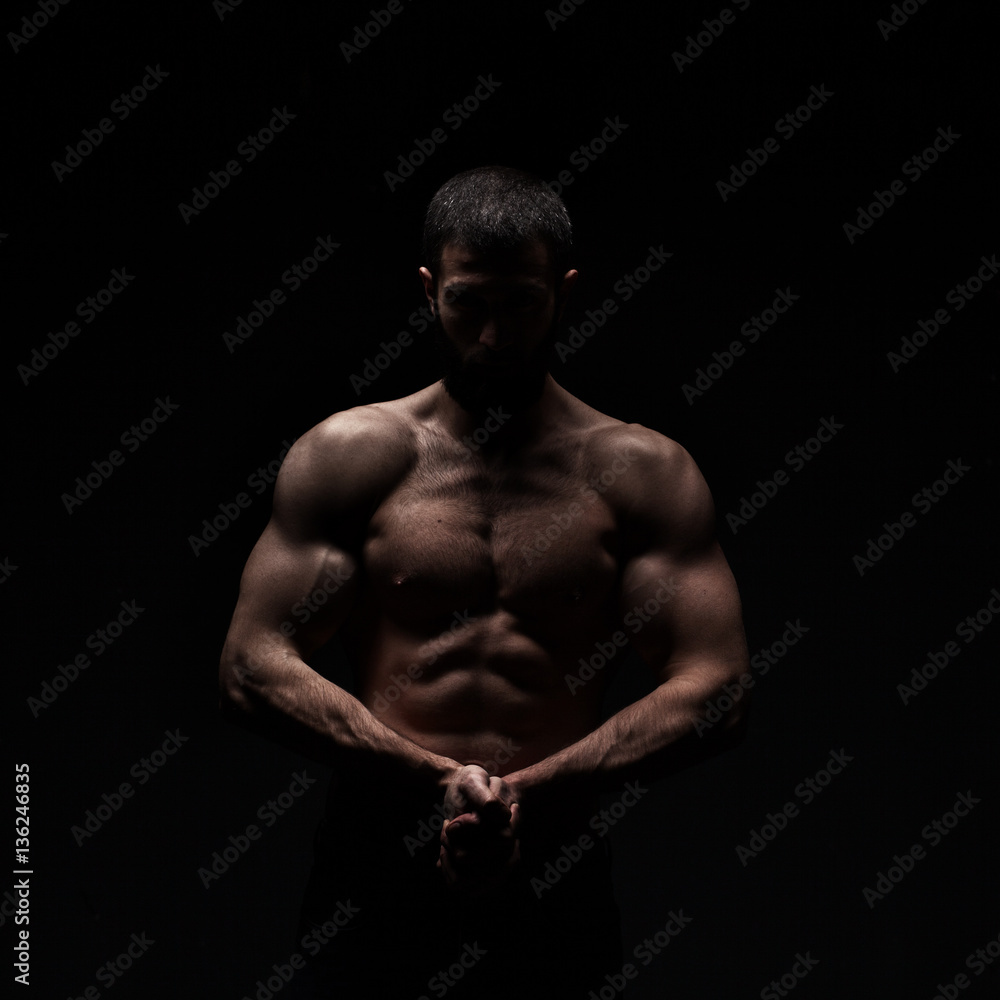 Fototapeta premium studio portrait of athlete bodybuilder man isolated over black background