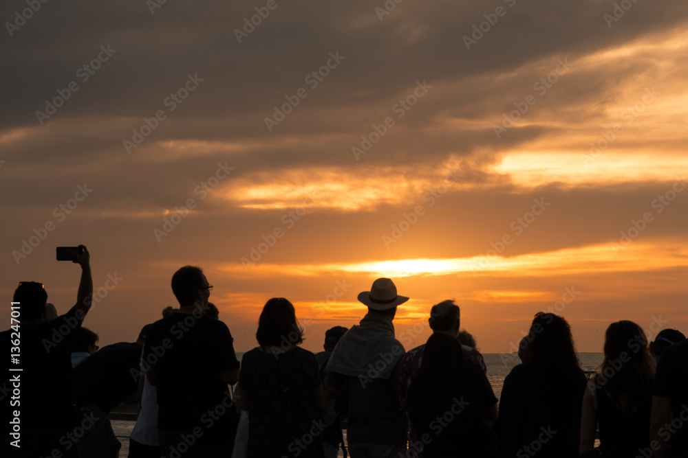 Silhouette Of People Watching Sunset On Ocean