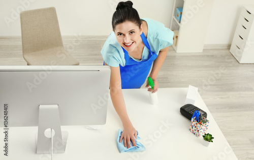 Young woman cleaning comput...