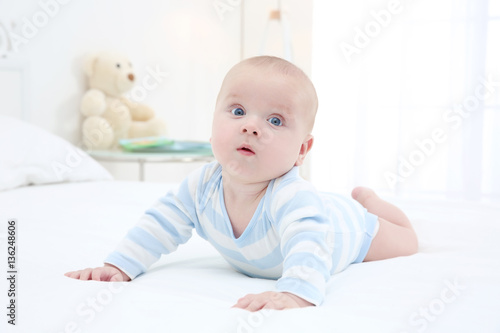 Cute baby lying on bed