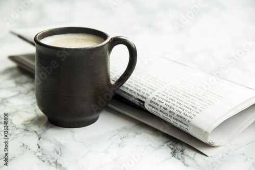 morning coffee and newspaper on the marble table