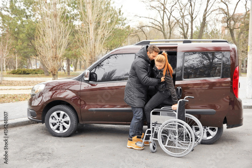 Young man helping handicapp...