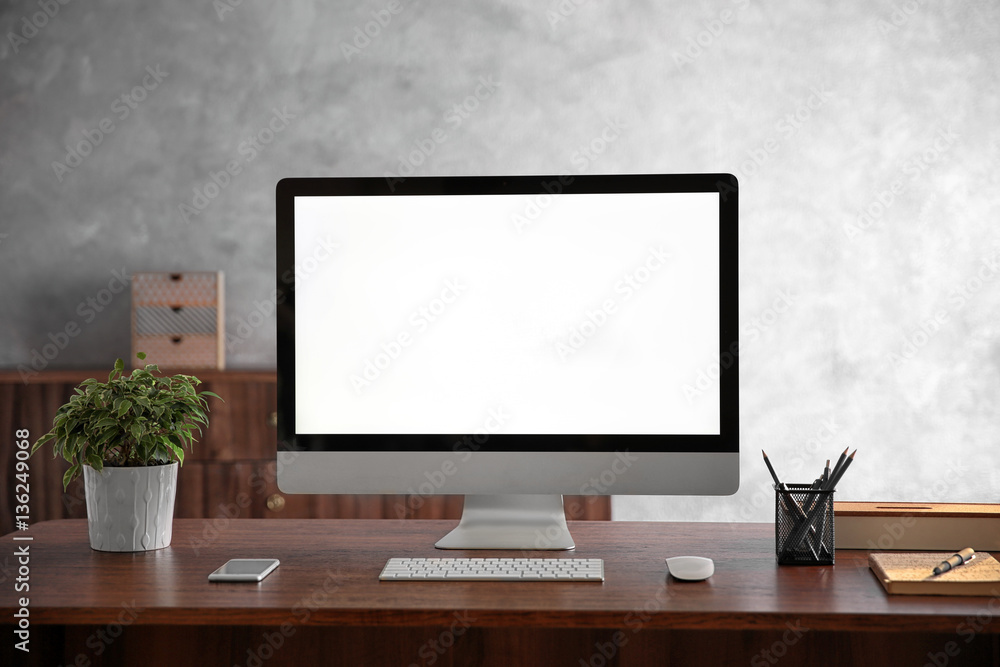 Modern computer monitor on wooden desk Modern computer monitor on wooden desk