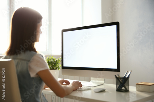 Woman working on computer at home