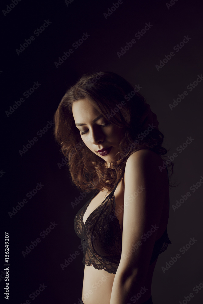 Beautiful young woman in sexy lace lingerie in the shadows Beautiful young woman in sexy lace lingerie in the shadows