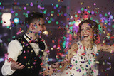 Cute happy wedding couple against defocused lights
