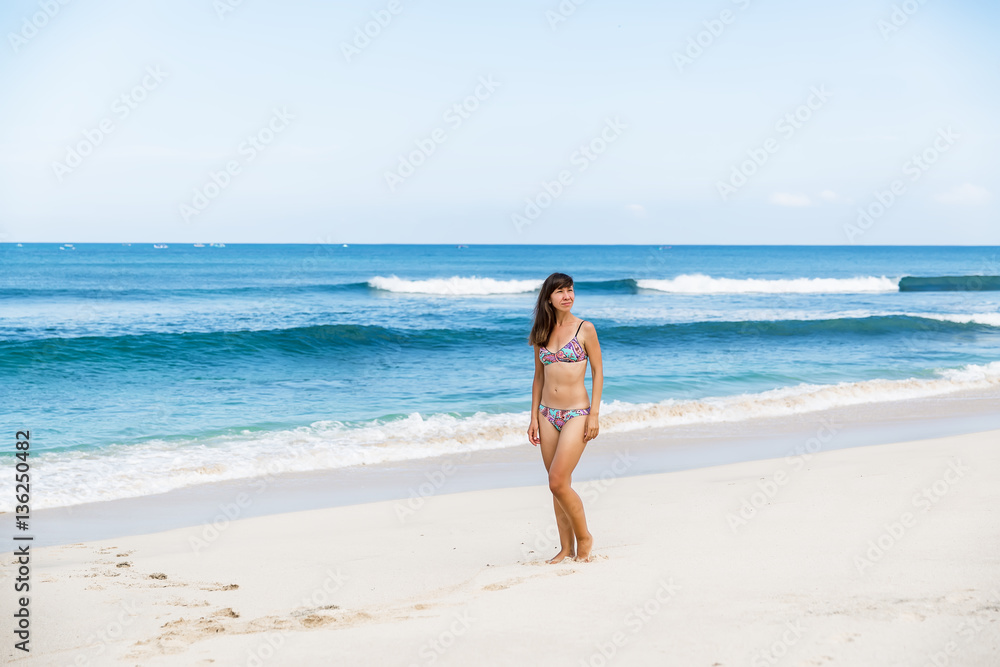 Beautiful woman in bikini. Young and sporty girl on a tropical beach. Beautiful woman in bikini. Young and sporty girl on a tropical beach.