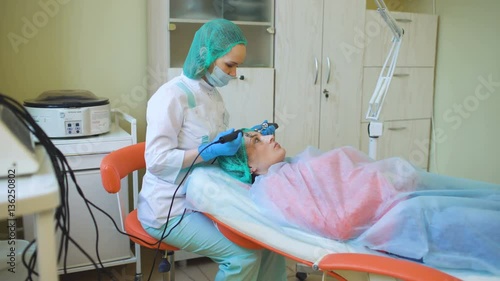 Cosmetology doctor female makes treatment procedure her patient in medical center photo