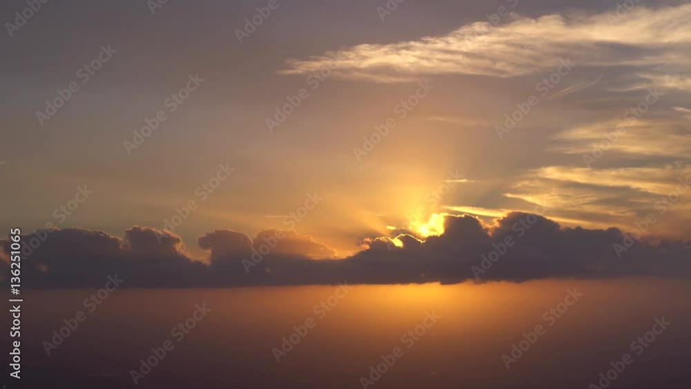 Aerial sunset behind clouds, Rays, Golden light Aerial sunset behind clouds, Rays, Golden light