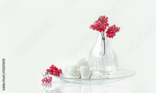 Canvas Print meringue with a branch of viburnum in glass transparent vase still life