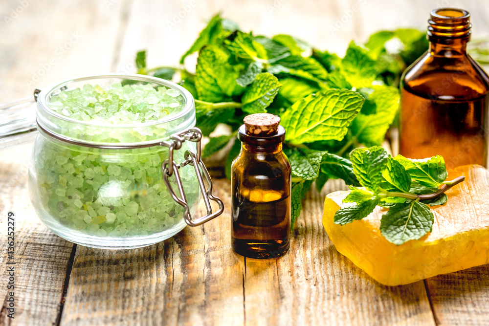 organic cosmetics with herbal extracts of mint on wooden background organic cosmetics with herbal extracts of mint on wooden background