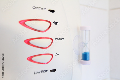 Egg timer attached to electric shower to reduce water and power usage