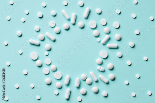 white pills on blue background photo