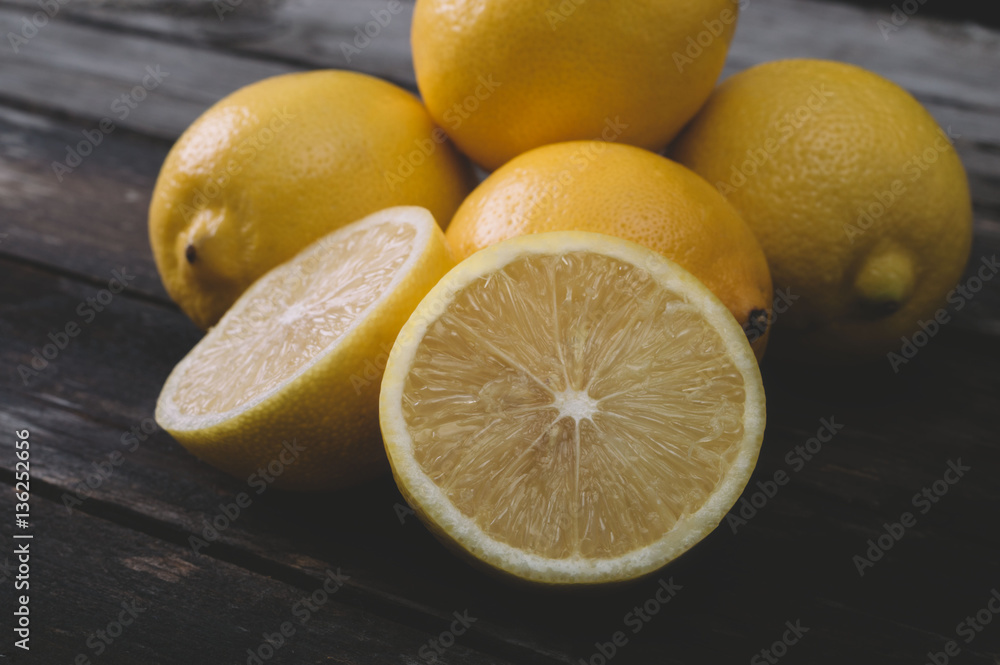 Fresh lemons on an old wooden table. Selective focus and small depth of field. Fresh lemons on an old wooden table. Selective focus and small depth of field.