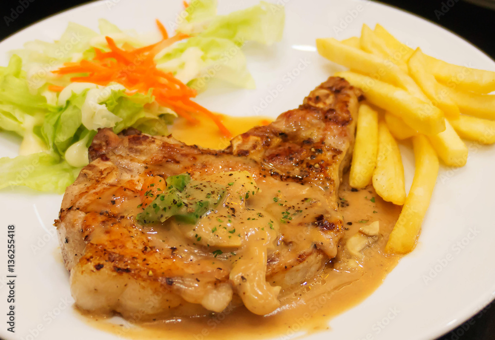 grilled porkchop on white plate grilled porkchop on white plate