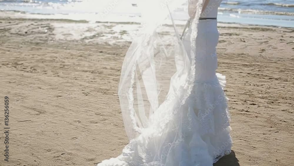 Bride walk on the beach at sunny day Bride walk on the beach at sunny day