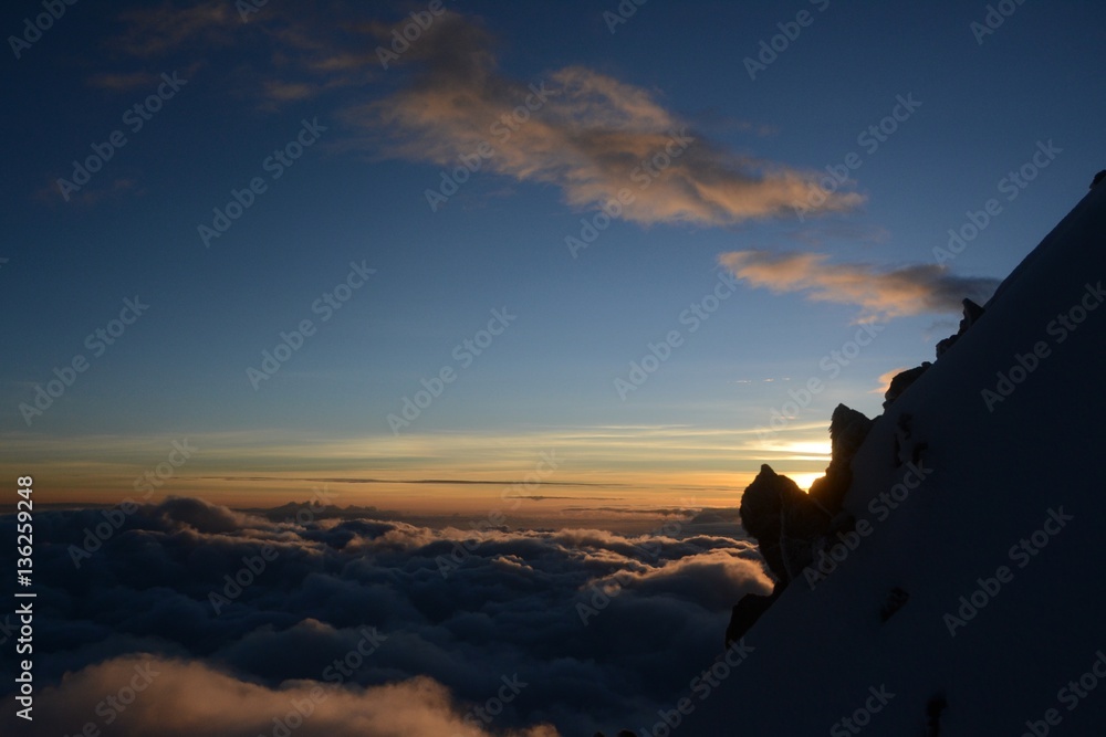 First light from high in the Andes above the clouds on Huayna Potosi.