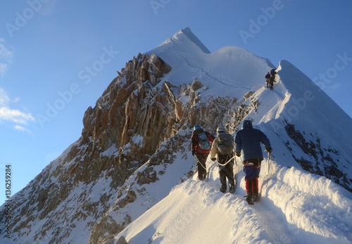Team of three Mountaineers push the last bit to the spectacular summit of Huayna Potosi.