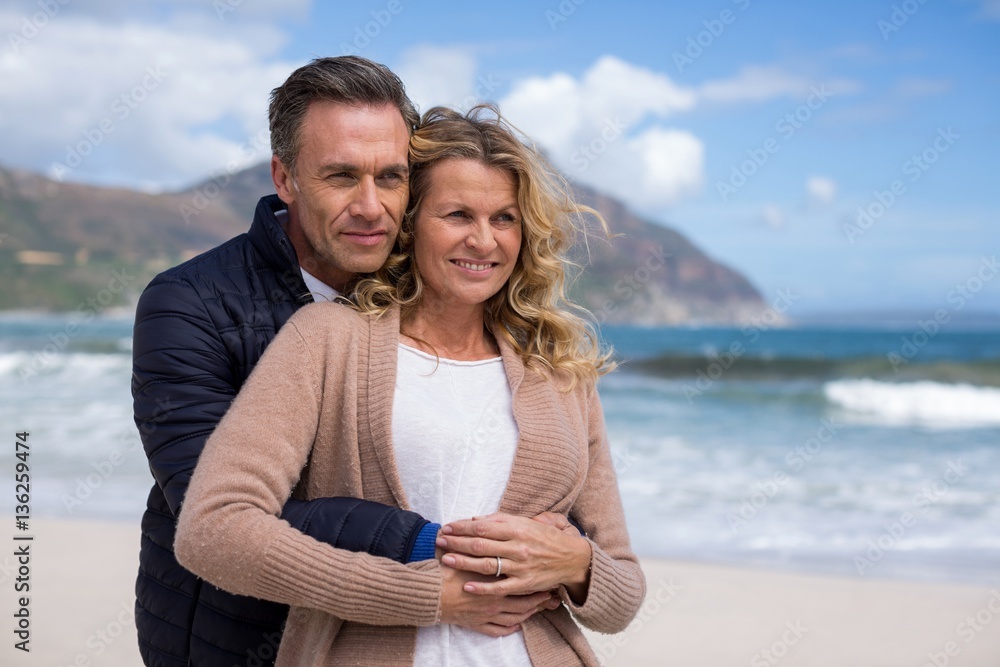 Mature couple embracing each other on the beach