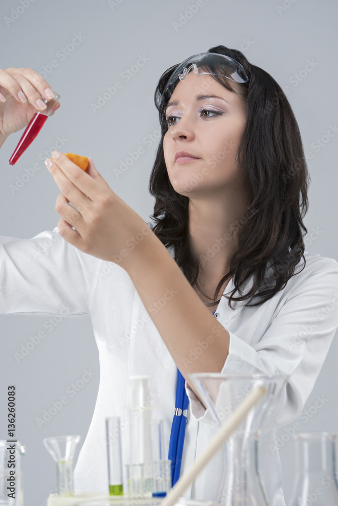 Portrait of Female Laboratory Staff with Flask and Tangerine Testing in Lab Portrait of Female Laboratory Staff with Flask and Tangerine Testing in Lab