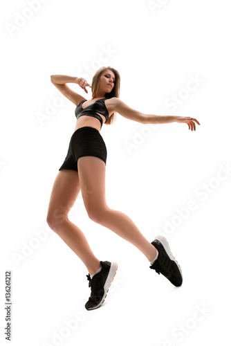 Dancer in sneakers performing on white background