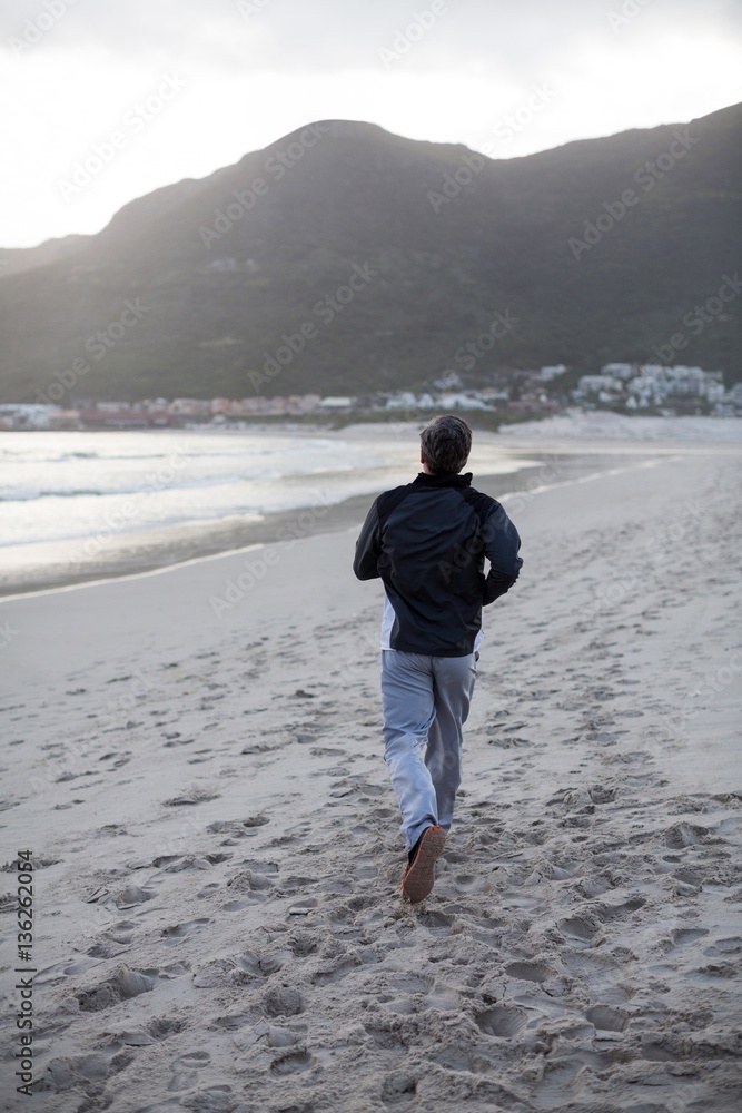 Mature man jogging on the beach