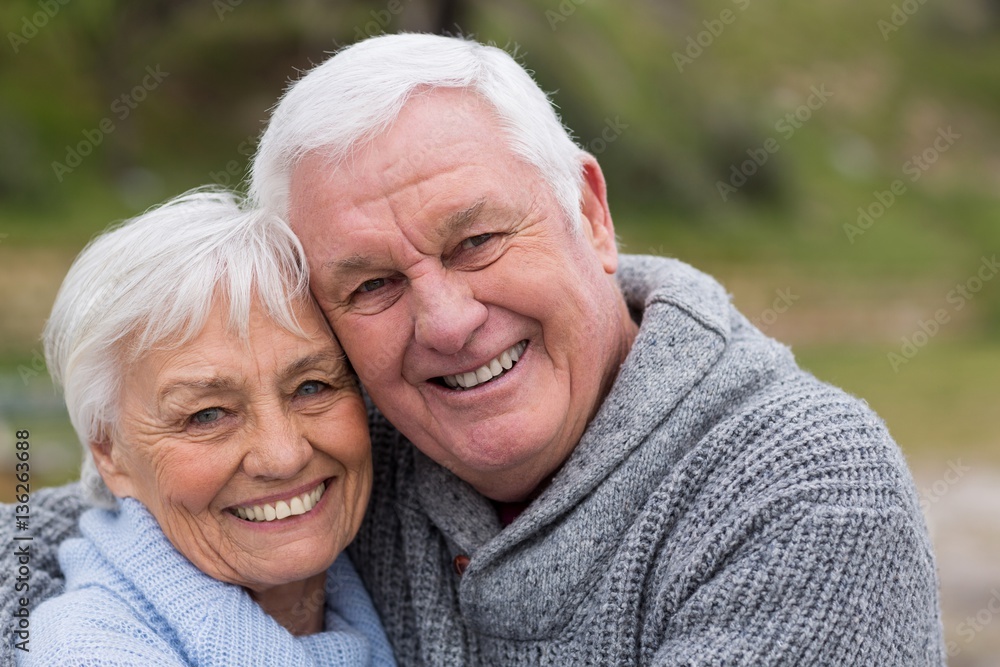 Happy senior couple standing together on the beach Happy senior couple standing together on the beach