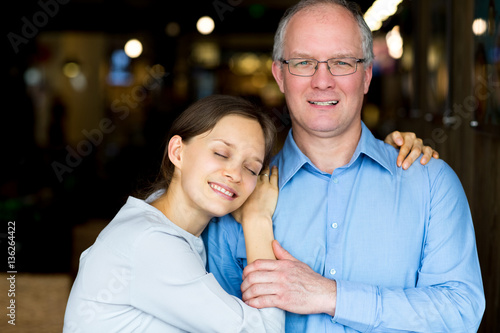 Content Adult Woman Embracing Middle-aged Father