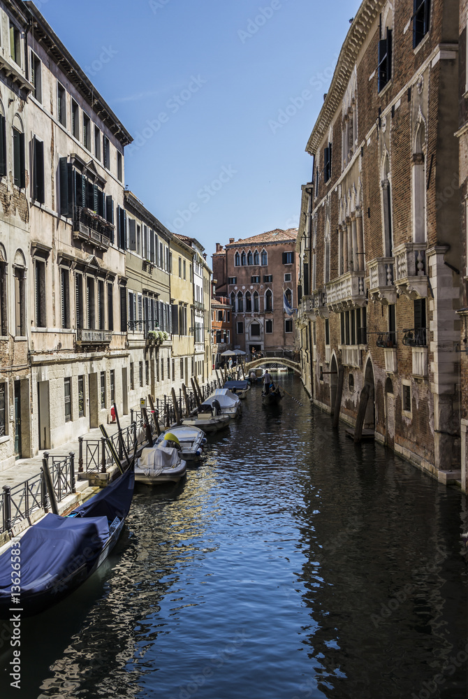 medieval architecture, houses, bridges, squares and boats on the canal-streets of Venice, Italy