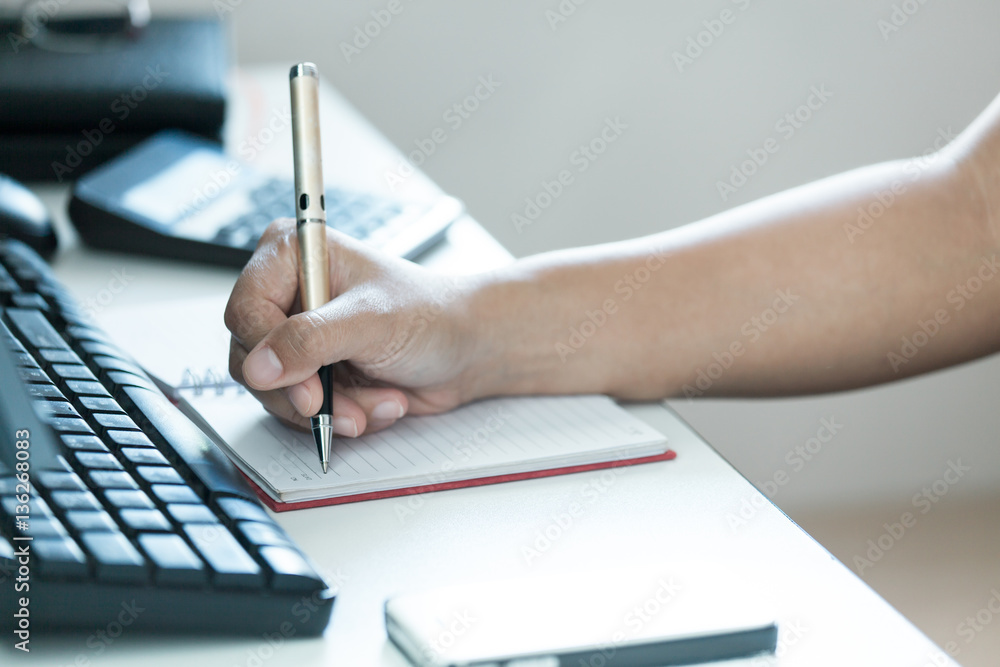 Focus of hand modern women take notes on table Focus of hand modern women take notes on table