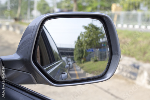 Side rear-view mirror on a modern car © oppos