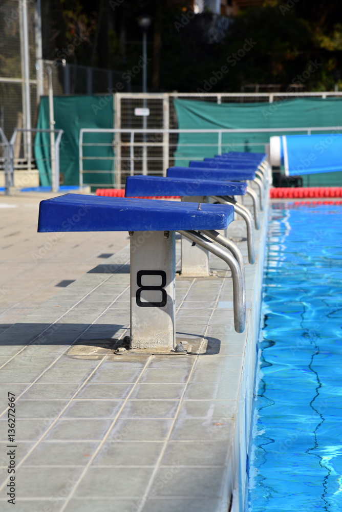Naklejka premium starting blocks at swimming pool 