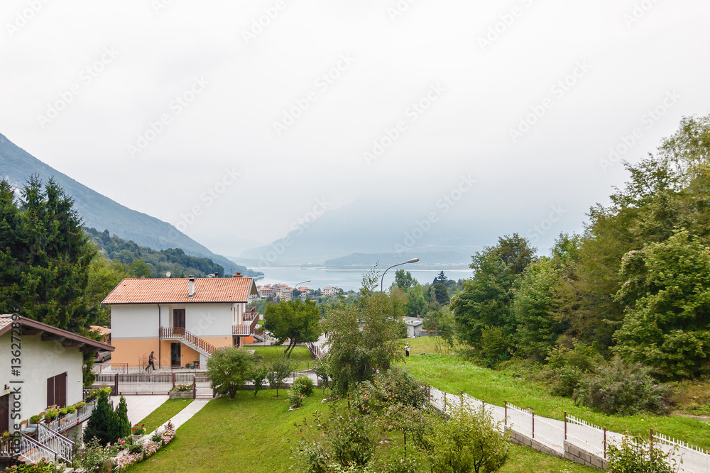 Houses at the coast of Lake Of Santa Croce in Dolomite Alps, Veneto region, Italy. Houses at the coast of Lake Of Santa Croce in Dolomite Alps, Veneto region, Italy.
