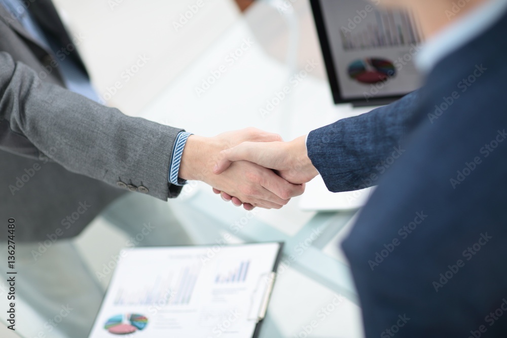 businessman shaking hands to seal a deal with his partner