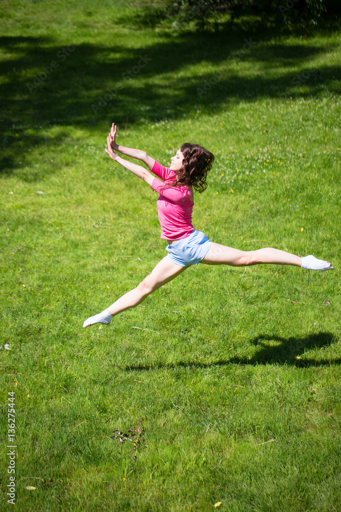 Young attractive woman jumping against green of summer park. Young attractive woman jumping against green of summer park.