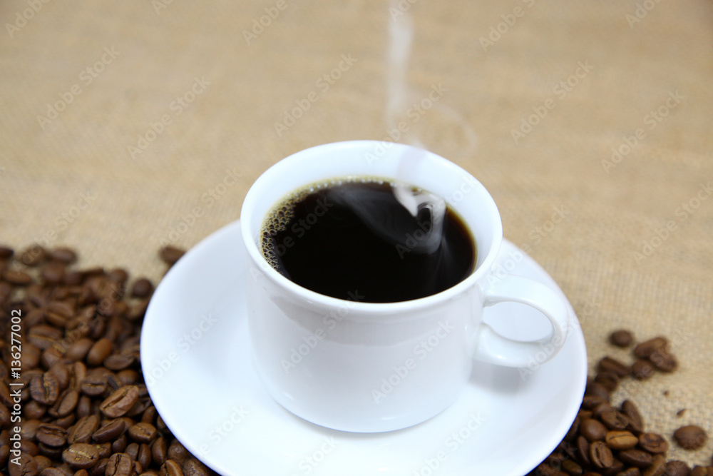 Hot coffee with a background of coffee beans Hot coffee with a background of coffee beans