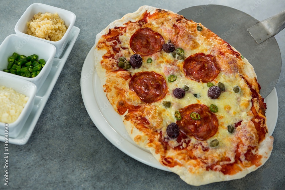 Italian pizza being served on a plate