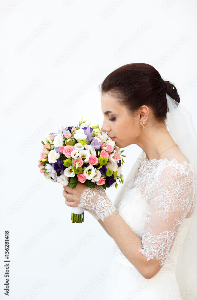 young wife sniffing the bouquet of colored flowers young wife sniffing the bouquet of colored flowers