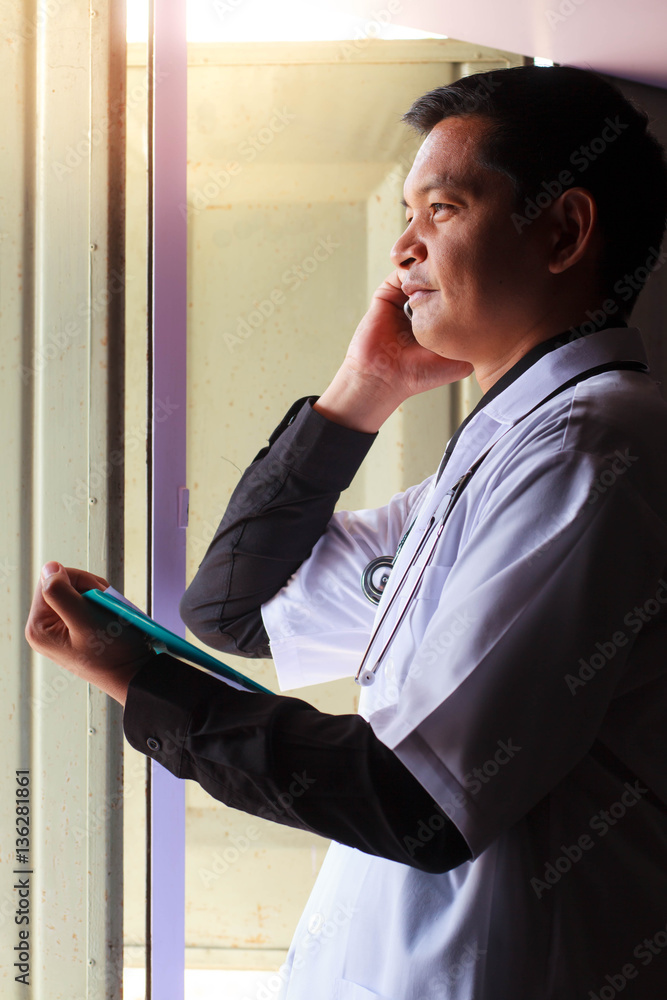 Fototapeta premium Asian doctor used smartphone.