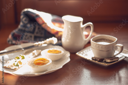 Breakfast  boiled egg  crisp with cream cheese and coffee with milk