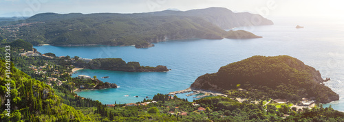 Beautiful summer panoramic seascape. View of the coastline into the sea bays with crystal clear azure water. In the backlight sunbeam light. Paleokastrica. Corfu. Ionian archipelago. Greece. photo