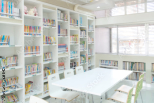 blurred bookshelf in library room for background