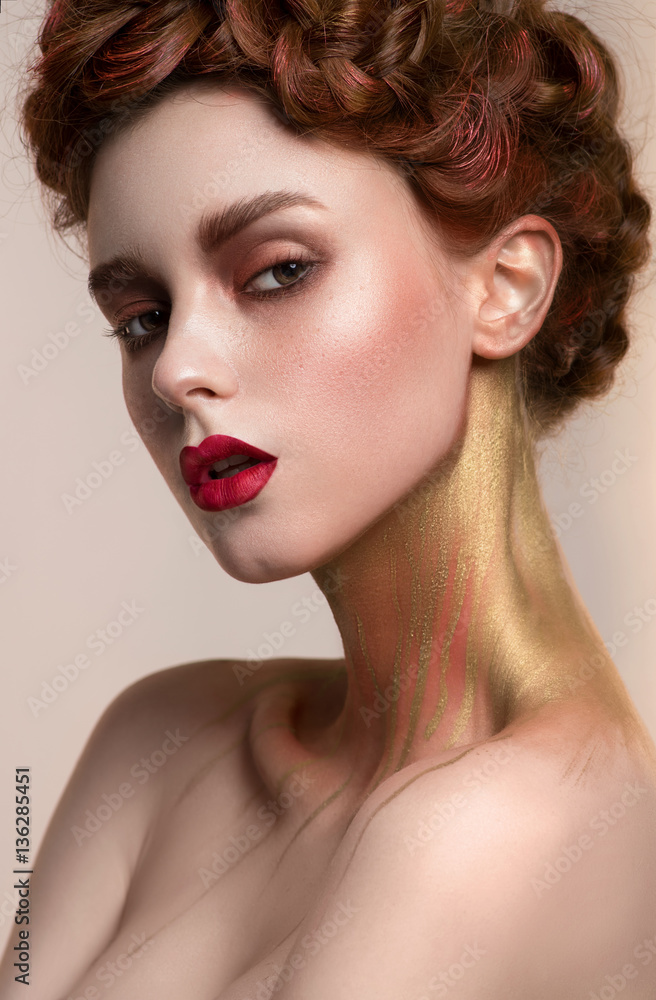 Girl with golden makeup posing in studio Girl with golden makeup posing in studio