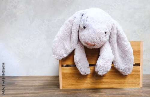 brick background with cute rabbit toy