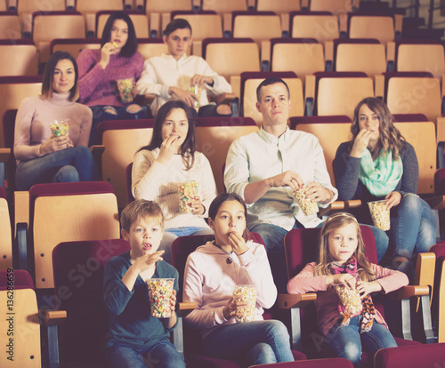 Numerous audience attending movie night with popcorn